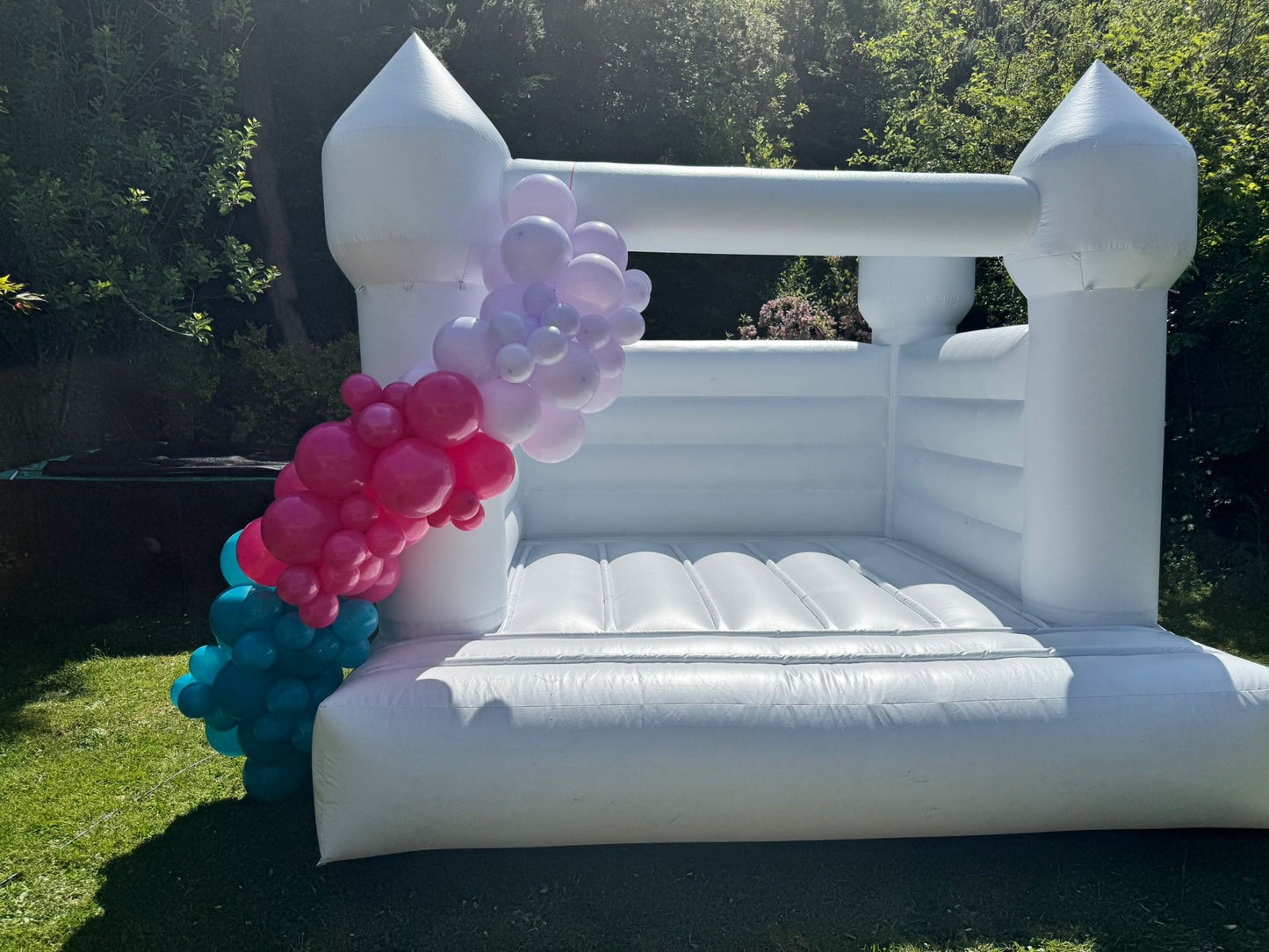 White Bouncy Castle with Custom Colour Balloon Garland - Pink, Blue and Lavender