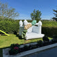 White Bouncy Castle with Custom Green & Gold Balloon Garland in a Back Garden 